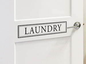 Laundry room wall decal that says ‘Laundry’ on a laundry room door.