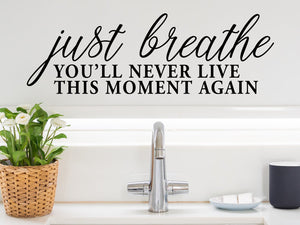 Wall decals for the bathroom that say ‘just breath you'll never live this moment again’ on a bathroom wall.