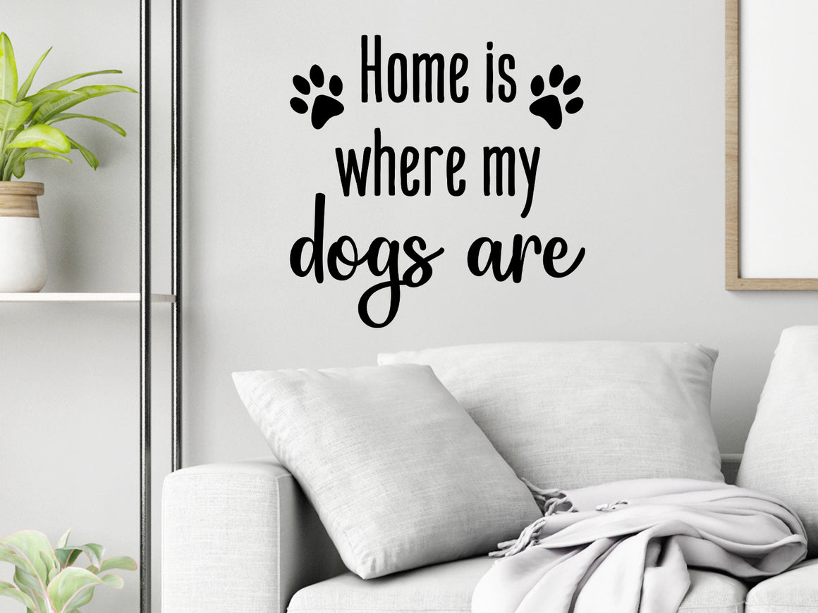 Living room wall decals that say ‘Home Is Where My Dogs Are’ in a script font on a living room wall. 