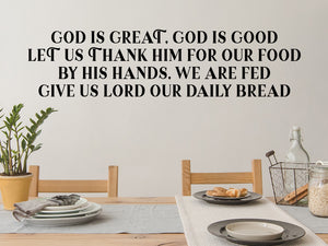 Decorative wall decal that says ‘God is Great, God Is Good’ on a kitchen wall.
