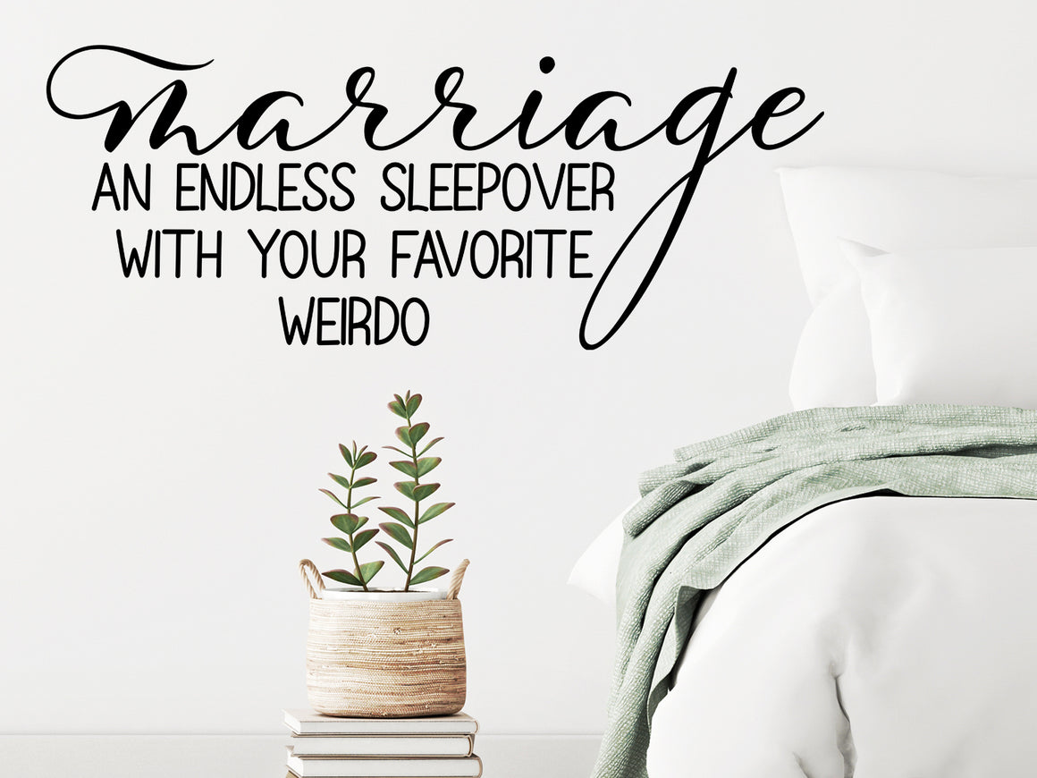 Wall decal for bedroom that says ‘marriage an endless sleepover with your favorite weirdo’ on a bedroom wall.