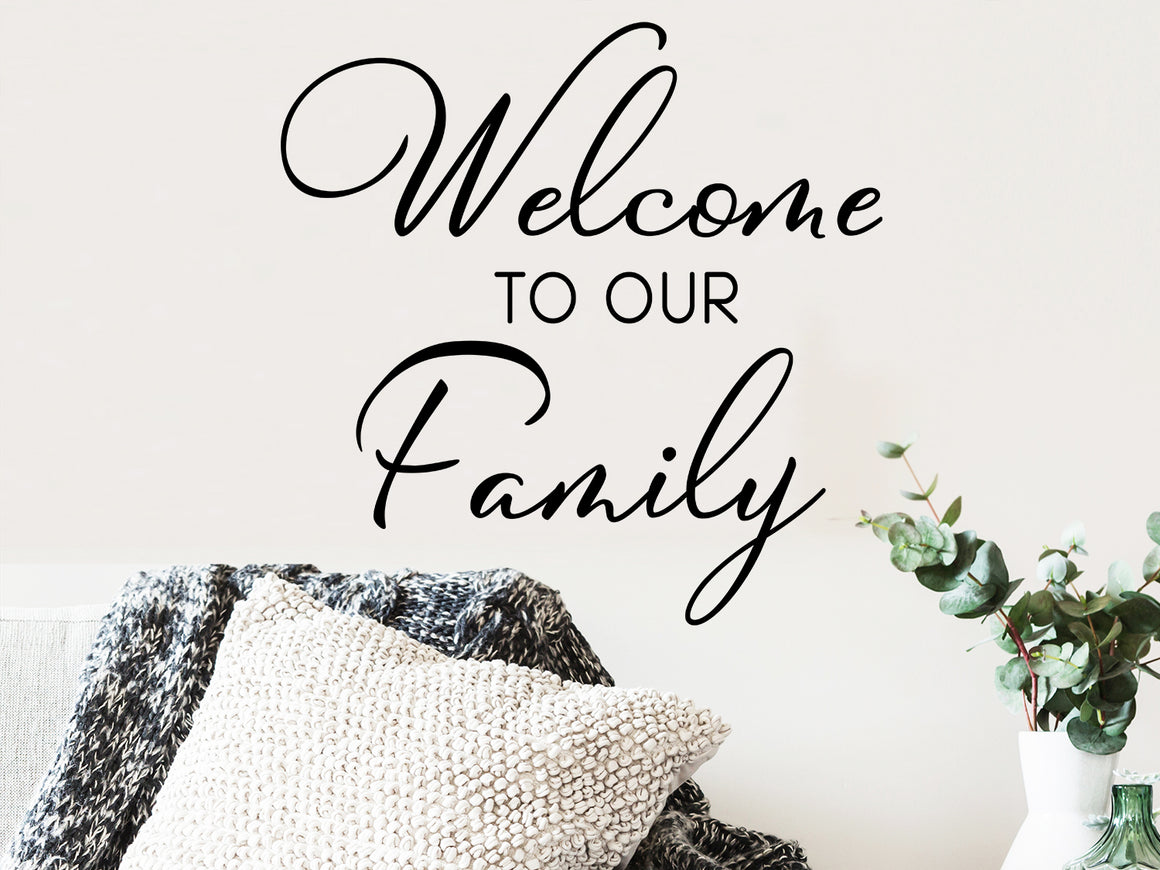 Living room wall decals that say ‘Welcome to our Family’ on a living room wall. 