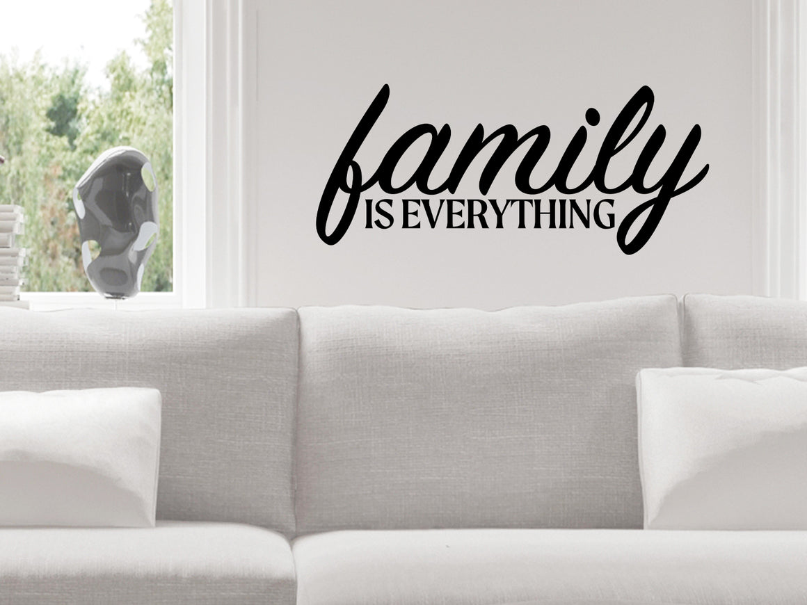 Living room wall decals that say ‘Family Is Everything’ in a bold font on a living room wall. 