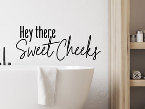Wall decal for the bathroom that says ‘hello there sweet cheeks’ on a bathroom wall.