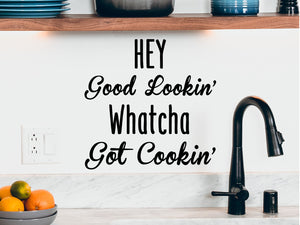 Decorative wall decal that says ‘Hey Good Lookin' Whatcha Got Cookin'’ on a kitchen wall.
