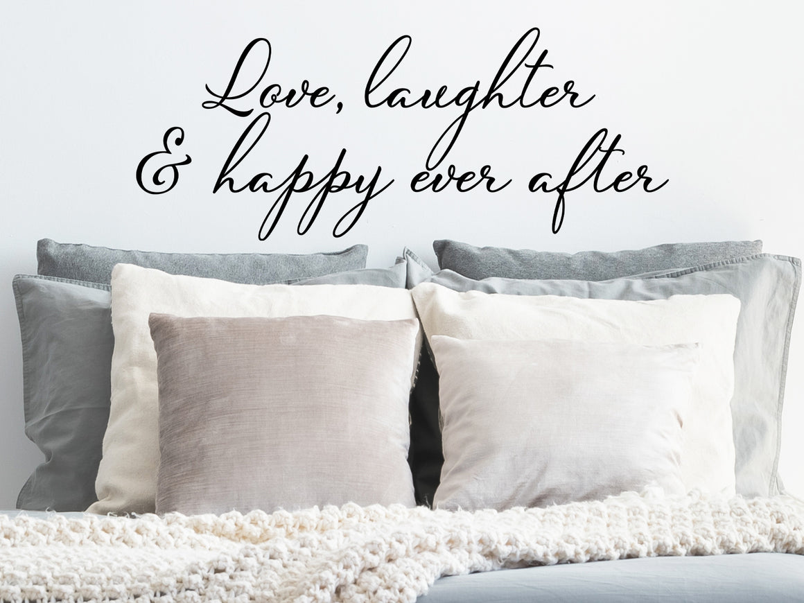 Wall decal for bedroom that says ‘love, laughter & happy ever after’ on a bedroom wall.