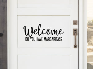 Front door decal that says, ‘Welcome Did You Bring Margaritas?’ on a front porch door. 