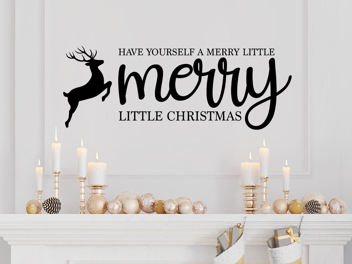 Living room wall decals that say ‘Have Yourself A Merry Little Christmas’ in a script font on a living room wall. 