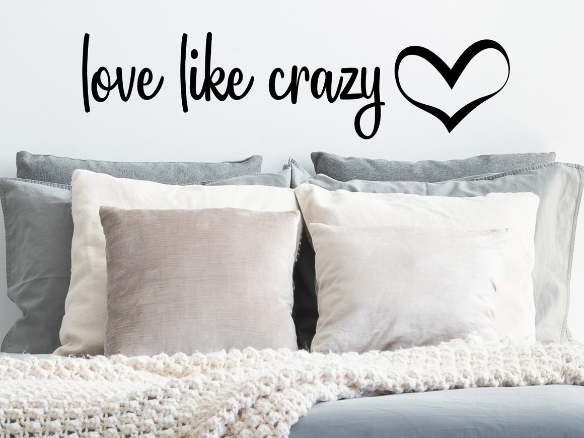 Wall decal for bedroom that says ‘love like crazy’ on a bedroom wall.