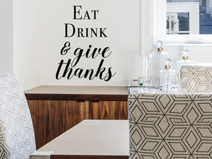 Wall decals for kitchen that say ‘Eat drink & give thanks’ on a kitchen wall.