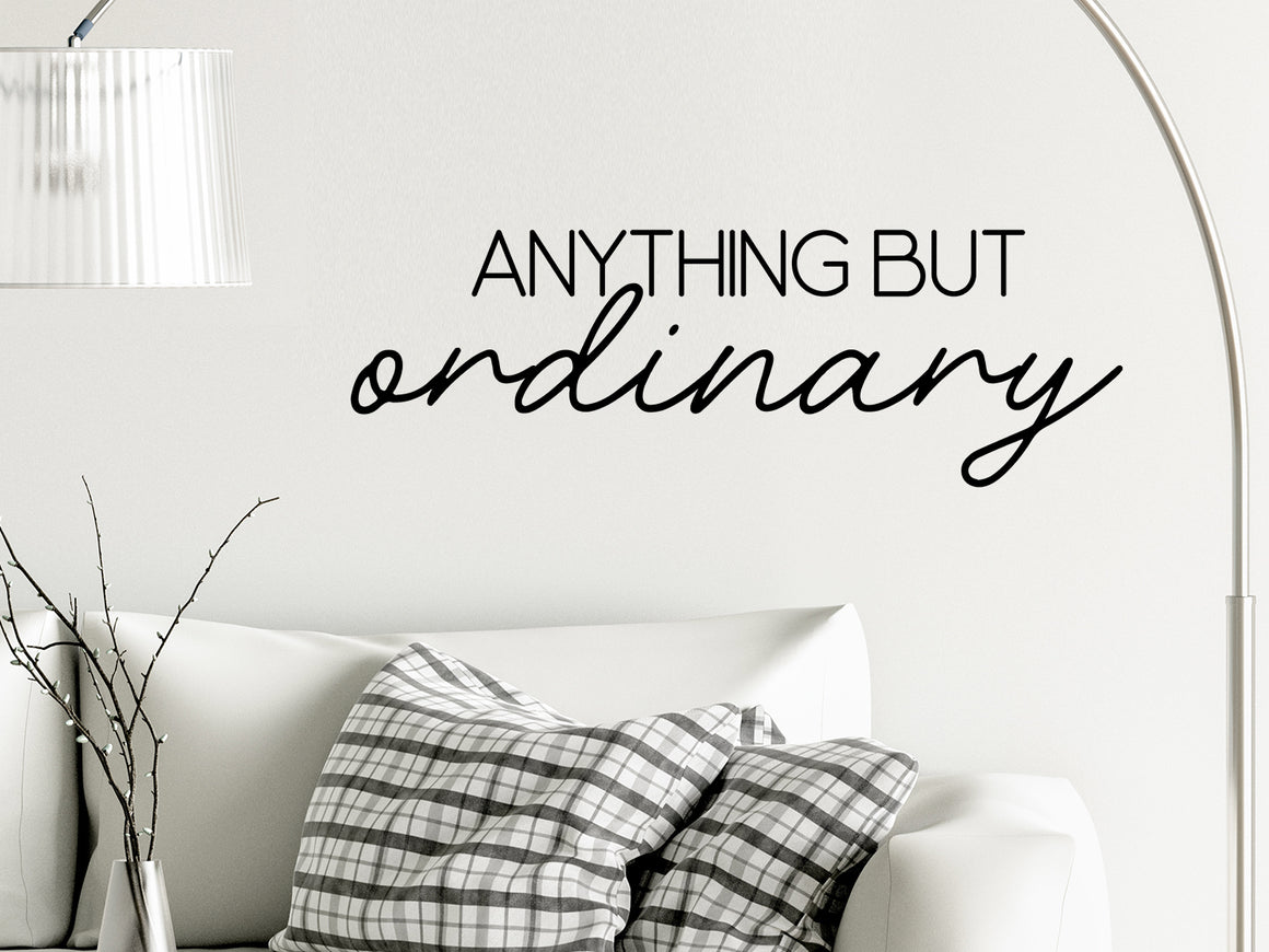 Living room wall decals that say ‘Anything but ordinary’ on a living room wall. 