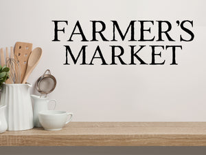 Wall decals for kitchen that say ‘Farmer's Market’ in a classic font on a kitchen wall.