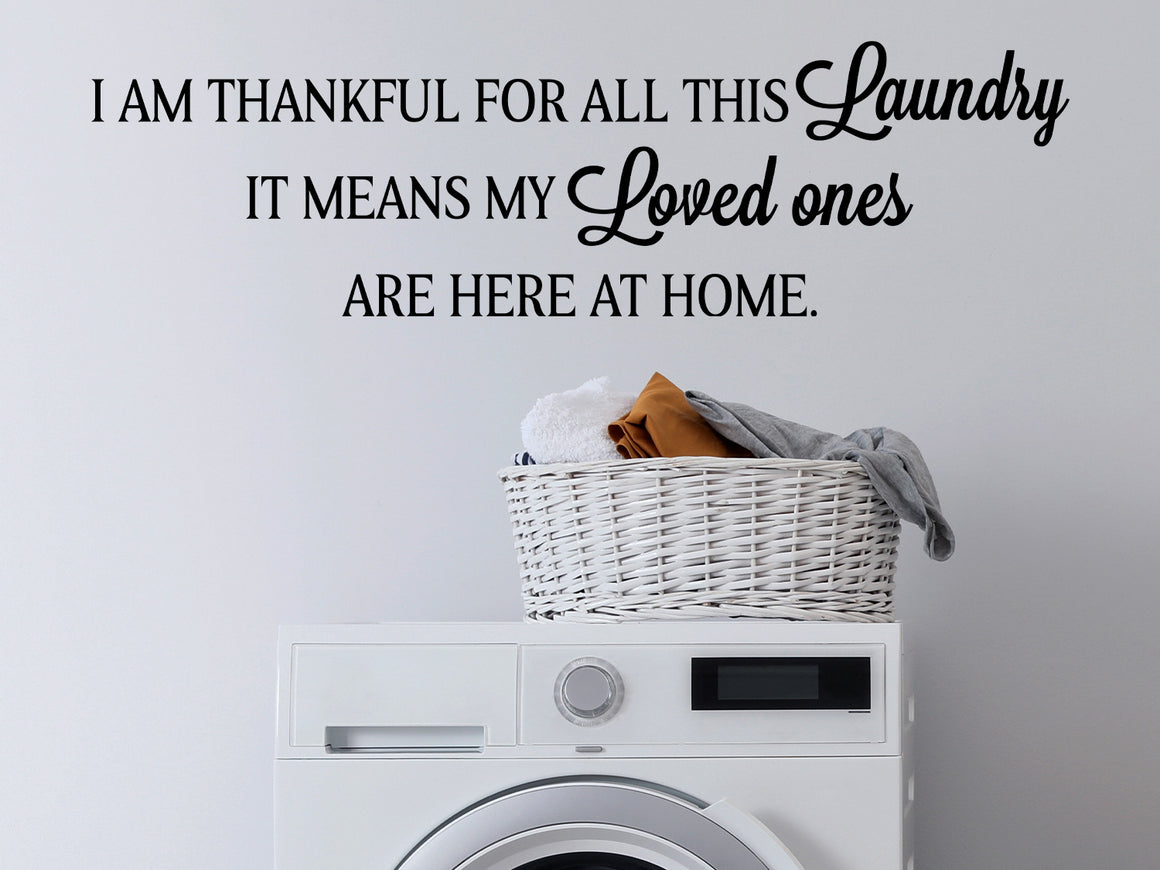 Laundry room wall decal that says ‘I Am Thankful For All This Laundry It Means My Loved Ones Are Here At Home’ on a laundry room wall.