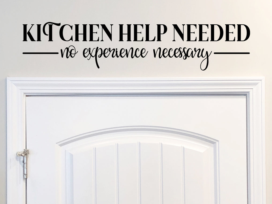 Decorative wall decal that says ‘Kitchen Help Needed No Experience Necessary’ on a kitchen wall.