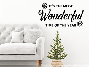 Living room wall decals that say ‘It's The Most Wonderful Time Of The Year’ with snowflakes on a living room wall. 