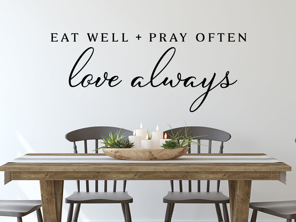 Wall decals for kitchen that say ‘Eat Well Pray Often Love Always’ in a print font on a kitchen wall.