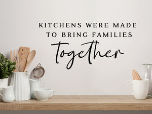 Wall decals for kitchen that say ‘Kitchens Were Made To Bring Families Together’ on a kitchen wall.