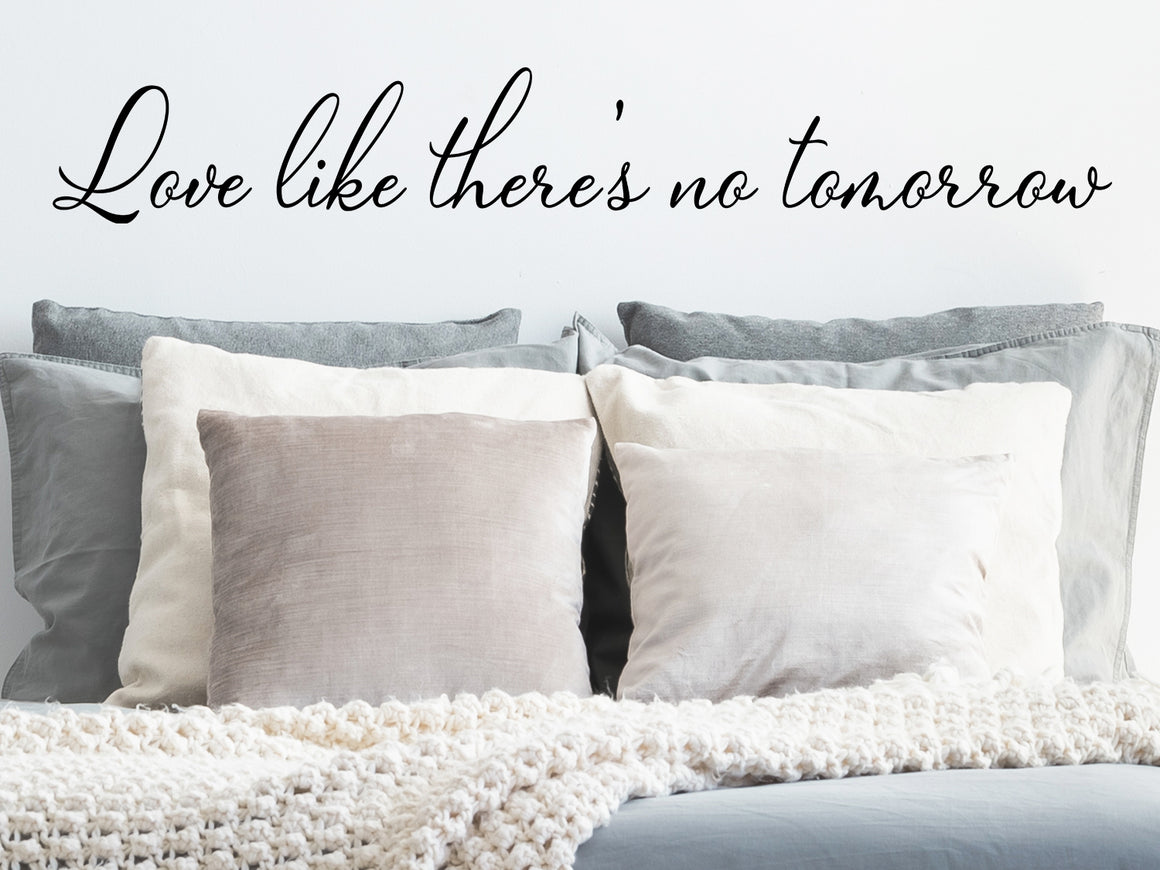 Wall decal for bedroom that says ‘love like there's no tomorrow’ on a bedroom wall.