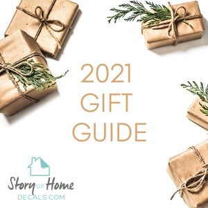 Graphic design with gold-wrapped presents and gold words that say, '2021 gift guide.'