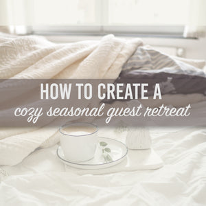 Image of a bed with a cup of coffee placed on a tray with a words across the image that say 'how to create a cozy seasonal guest retreat.'