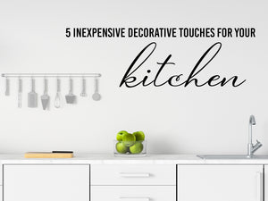 Wall decals for kitchen that say ‘5 Inexpensive Decorative Touches for Your Kitchen’ on a kitchen wall.