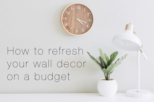 Stick on wall art that says, 'how to refresh your wall decor on a budget.'