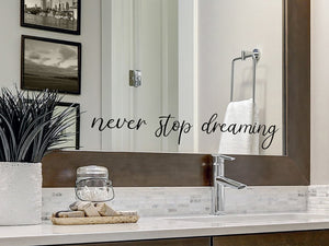 Wall decals for bathroom that say ‘never stop dreaming’ on a bathroom wall.