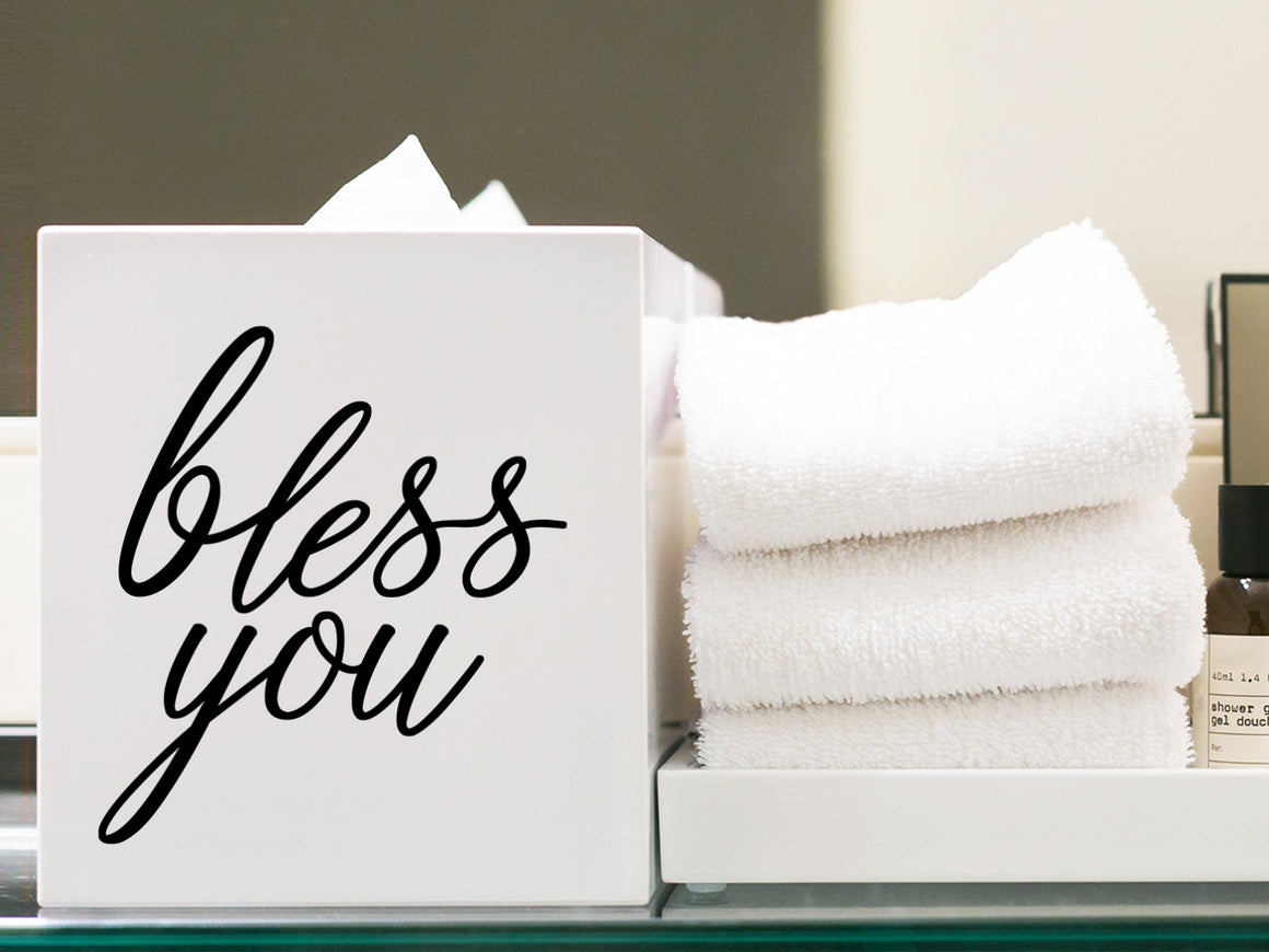 wall decal for bathroom that says ‘bless you’ on a tissue box.