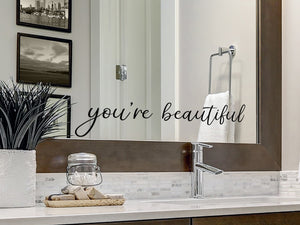 Wall decals for bathroom that say ‘you're beautiful’ on a bathroom wall.