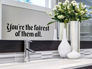 Wall decals for bathroom that say ‘You're the fairest of them all’ on a bathroom mirror.