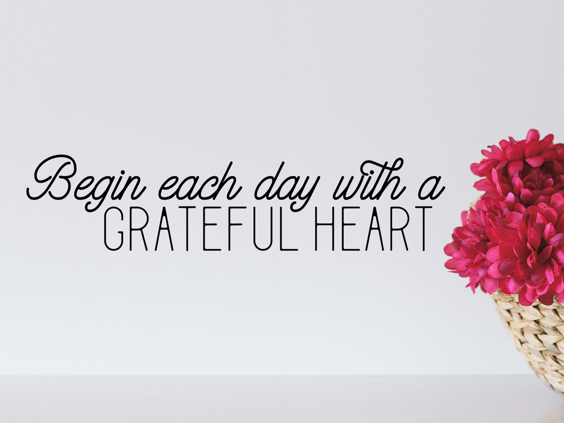 Wall decal for bathroom that says 'Begin Each Day With A Grateful Heart' on a bathroom wall. 