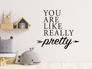 Wall decal for kids in a black color that says ‘You Are Like Really Pretty’ with an arrow design on a kid’s room wall. 
