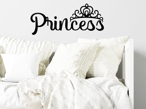 Wall decal for kids in black that says ‘Princess’ in a script font on a kid’s room wall. 