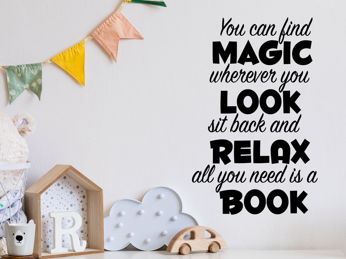 Wall decal for kids in a black color that says ‘You Can Find Magic Wherever You Look’ in a dual font on a kid’s room wall. 