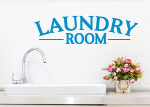 Laundry room wall decal in blue that says ‘laundry room’ on a laundry room wall.