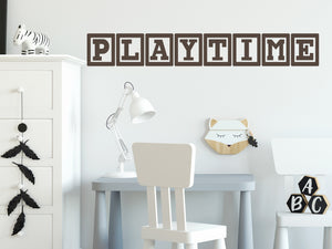 Wall decal for kids that says ‘Playtime’ in brown with blocks on a kid’s room wall. 