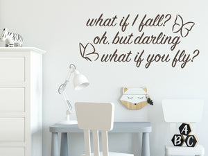Wall decal for kids in a brown color that says ‘What If I Fall, Oh But My Darling, What If You Fly?’ in a cursive font on a kid’s room wall. 