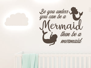 Wall decal for kids in a brown color that says ‘Always Be You Unless You Can Be A Mermaid’ on a kid’s room wall. 
