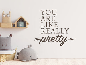 Wall decal for kids in a brown color that says ‘You Are Like Really Pretty’ with an arrow design on a kid’s room wall. 