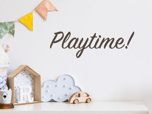Wall decal for kids that says ‘Playtime! Cursive’ on a kid’s room wall. 