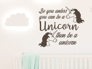 Wall decal for kids in a brown color that says ‘Always Be You Unless You Can Be A Unicorn’ on a kid’s room wall. 