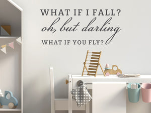 Wall decal for kids in a grey color that says ‘What If I Fall, Oh But My Darling, What If You Fly?’ in a script font on a kid’s room wall. 