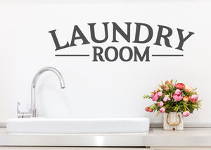 Laundry room wall decal in grey that says ‘laundry room’ on a laundry room wall.