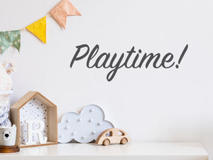 Wall decal for kids that says ‘Playtime! Cursive’ on a kid’s room wall. 