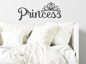 Wall decal for kids in grey that says ‘Princess’ in a script font on a kid’s room wall. 