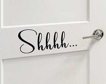 Decorative wall decal that say ‘Shhhh’ on a kid’s room wall. 