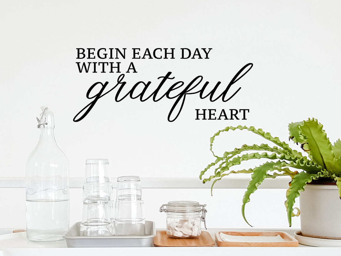Wall decals for kitchen that say ‘begin each day with a grateful heart’ on a kitchen wall.
