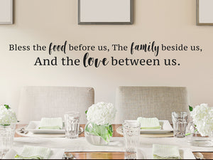 Wall decals for kitchen that say 'Bless the food before us the family beside us and the love between us' on a kitchen wall. 
