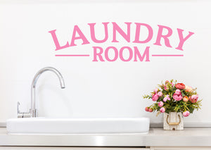 Laundry room wall decal in pink that says ‘laundry room’ on a laundry room wall.