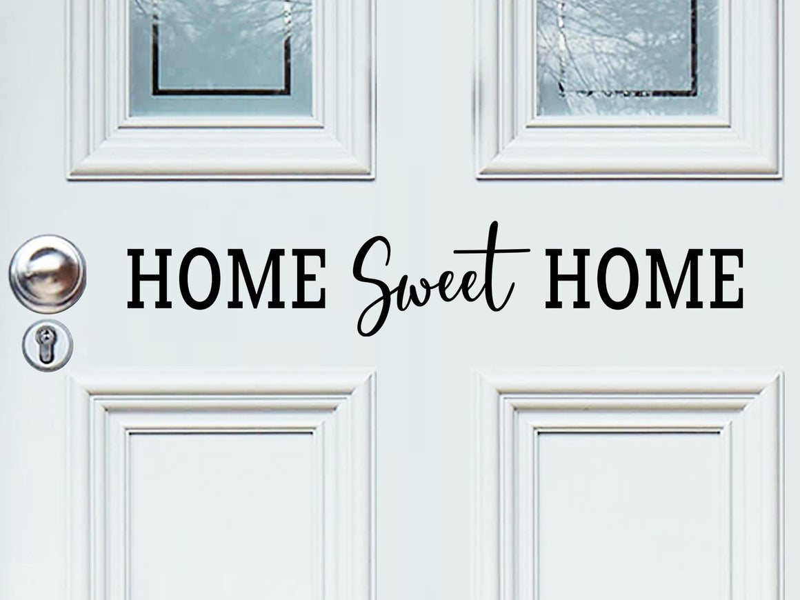 Front door decal that says, ‘home sweet home’ with a script font on a front porch door. 